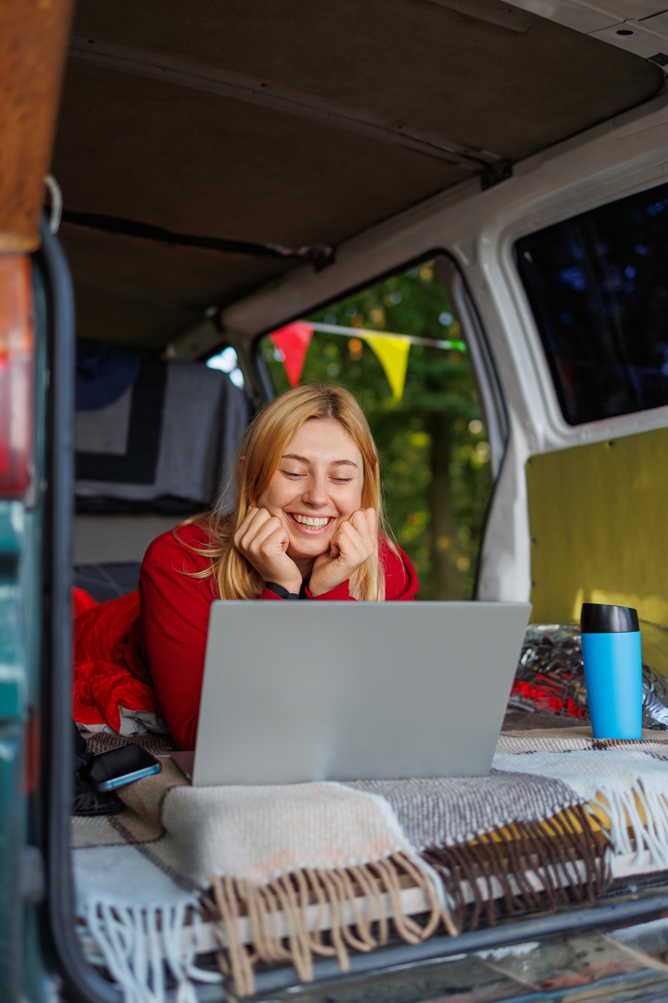 Woman in van looking at laptop