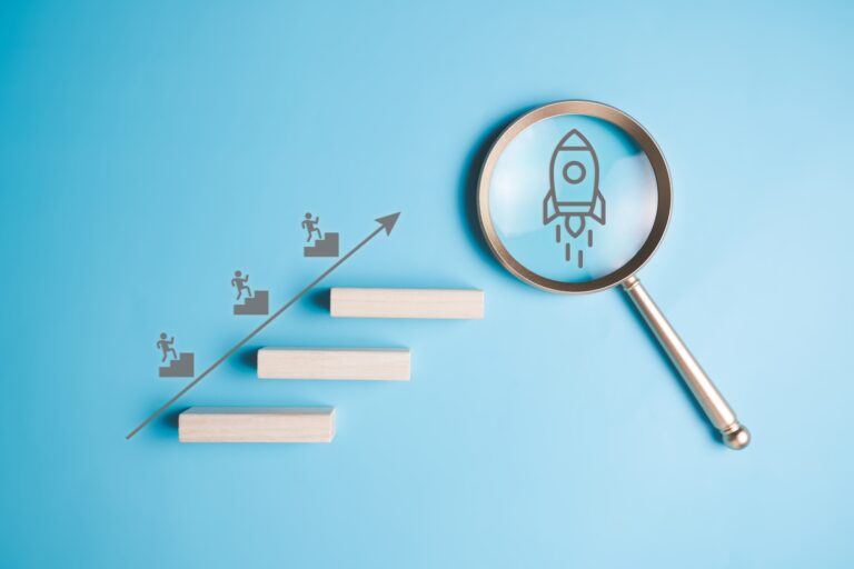 Magnifying glass with rocket icon for new project business goal